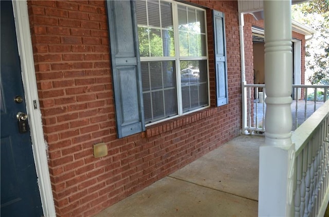 view of side of home with covered porch