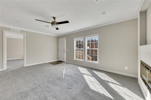 unfurnished living room featuring a textured ceiling, carpet floors, ceiling fan, and crown molding