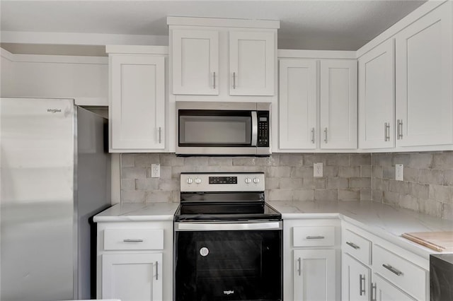 kitchen with white cabinets and appliances with stainless steel finishes