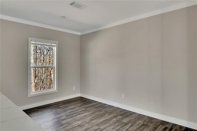 empty room with crown molding and dark wood-type flooring