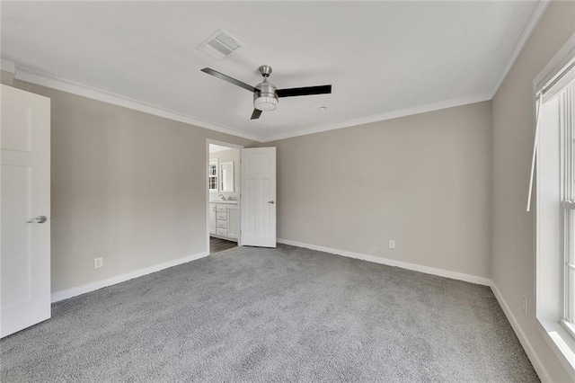 unfurnished bedroom featuring multiple windows, carpet floors, ceiling fan, and ornamental molding