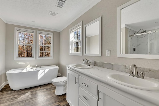 full bathroom featuring hardwood / wood-style floors, vanity, a textured ceiling, and shower with separate bathtub