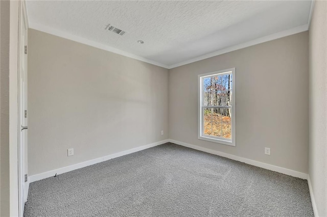 carpeted empty room with a textured ceiling and crown molding