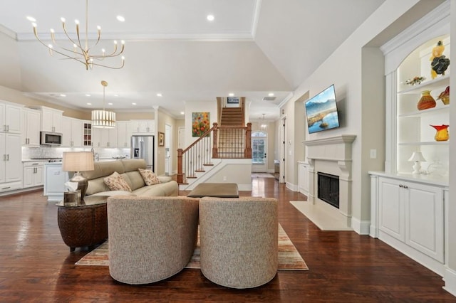 living room with ornamental molding, a chandelier, dark hardwood / wood-style floors, and lofted ceiling