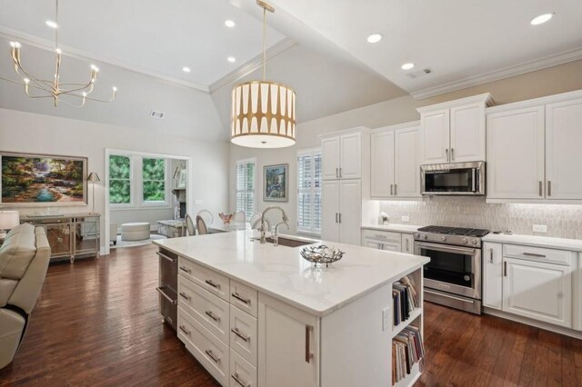 kitchen featuring white cabinetry, decorative light fixtures, stainless steel appliances, and dark hardwood / wood-style flooring