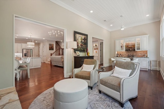 living room with wood ceiling, crown molding, a chandelier, and dark hardwood / wood-style floors