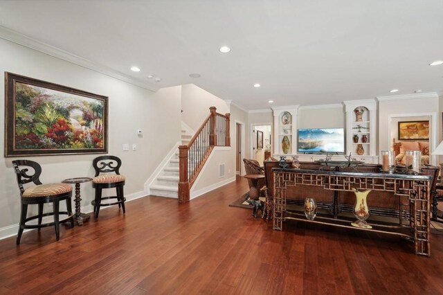 interior space with ornamental molding, indoor bar, and wood-type flooring