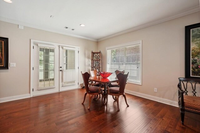 dining room with crown molding and dark hardwood / wood-style flooring