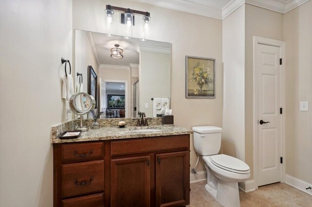 bathroom with vanity, toilet, ornamental molding, and tile patterned flooring