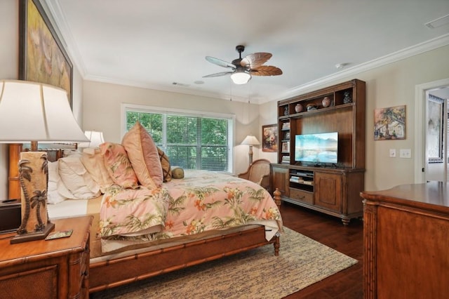 bedroom featuring ornamental molding, dark wood-type flooring, and ceiling fan