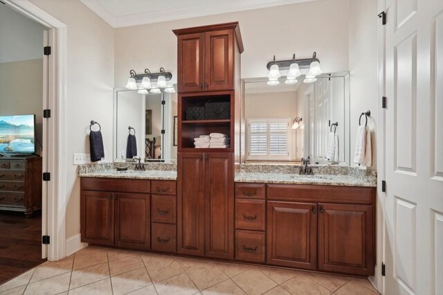 bathroom with vanity, ornamental molding, and tile patterned flooring