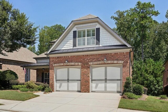 view of front of property featuring a garage and a front lawn