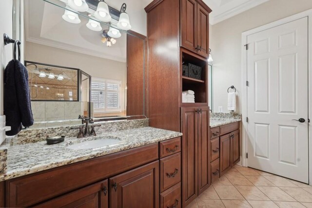 bathroom with vanity, crown molding, a shower with shower door, and tile patterned floors