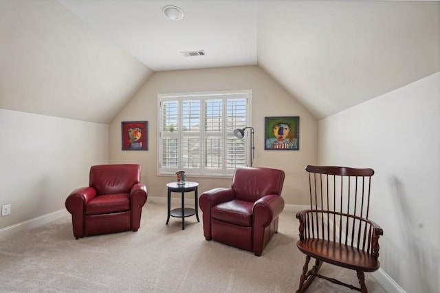 living area with lofted ceiling and light colored carpet