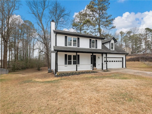 front facade with a porch, a garage, and a front yard