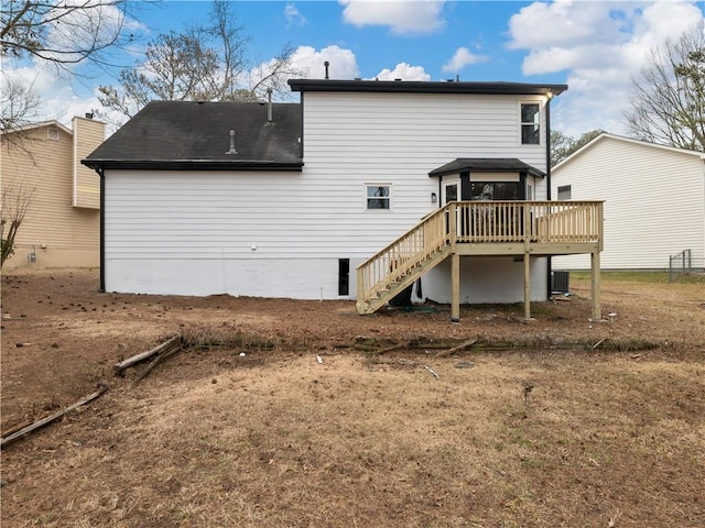 rear view of house featuring a wooden deck and central air condition unit