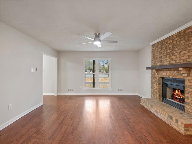 unfurnished living room featuring ceiling fan, dark wood-type flooring, and a fireplace