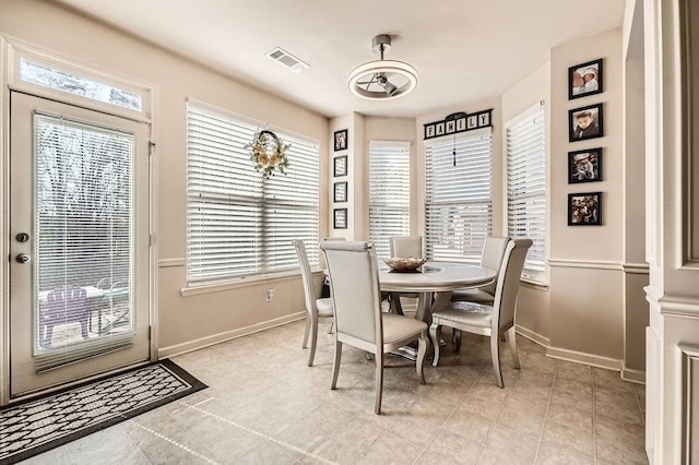 dining area with a wealth of natural light, visible vents, and baseboards