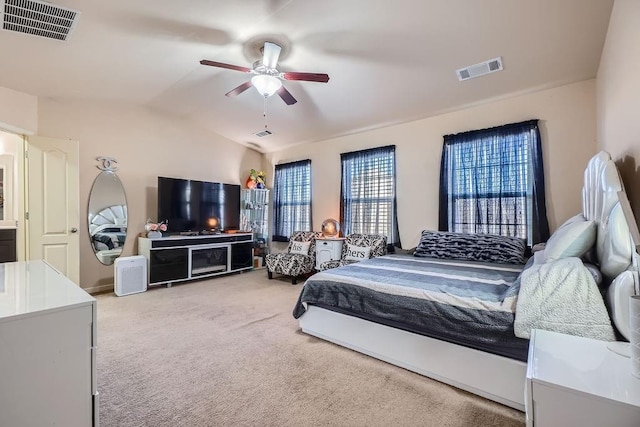 carpeted bedroom featuring visible vents, a ceiling fan, and lofted ceiling