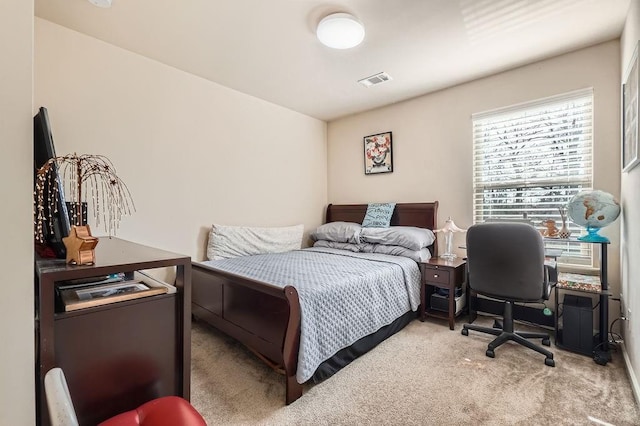 bedroom with visible vents and carpet flooring