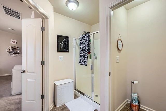 full bath featuring visible vents, a stall shower, and baseboards