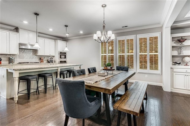4831 Miller Hill Rd, Buford, GA 30518 - dining space with a chandelier, ornamental molding, dark wood-type flooring, recessed lighting, and baseboards