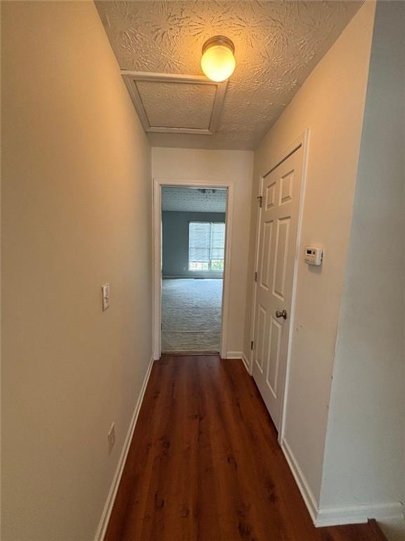6231 Redan Overlook, Lithonia, GA 30058 - hall featuring dark wood-type flooring, baseboards, and attic access