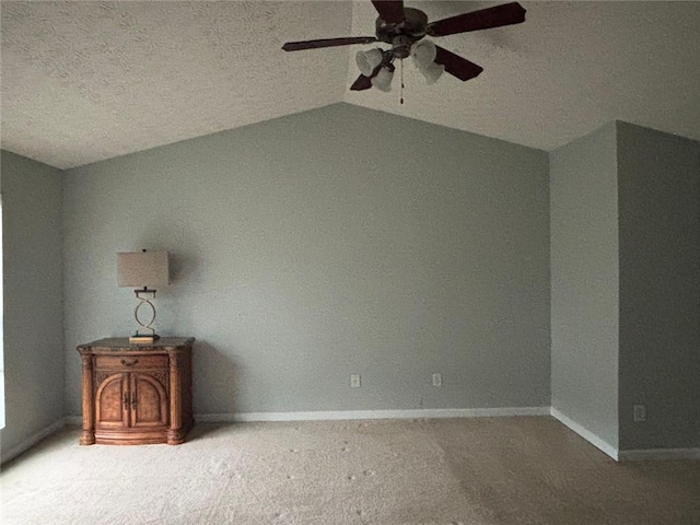 6231 Redan Overlook, Lithonia, GA 30058 - unfurnished bedroom featuring a textured ceiling, baseboards, carpet flooring, vaulted ceiling, and ceiling fan