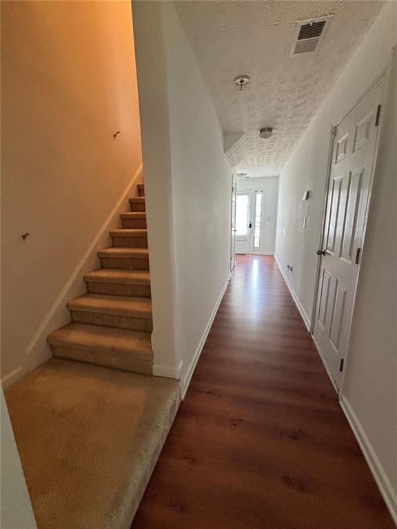 6231 Redan Overlook, Lithonia, GA 30058 - hallway featuring wood finished floors, stairway, a textured ceiling, and baseboards