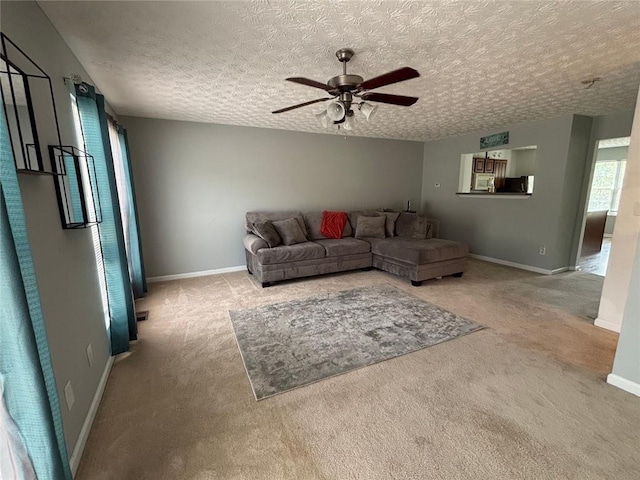6231 Redan Overlook, Lithonia, GA 30058 - carpeted living room featuring ceiling fan, baseboards, and a textured ceiling