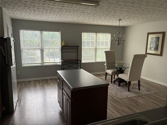 6231 Redan Overlook, Lithonia, GA 30058 - dining area featuring healthy amount of natural light, a chandelier, baseboards, and dark wood finished floors