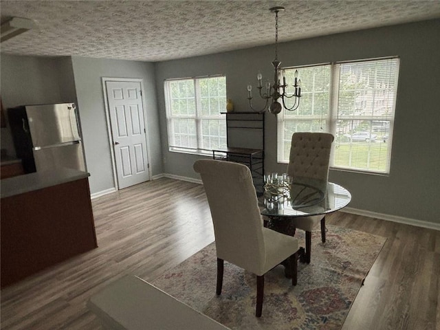 6231 Redan Overlook, Lithonia, GA 30058 - dining area with a textured ceiling, baseboards, a chandelier, and wood finished floors