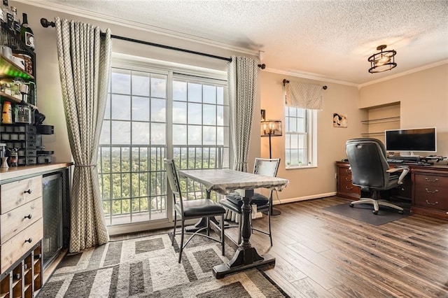 home office with crown molding, a textured ceiling, plenty of natural light, and wood finished floors