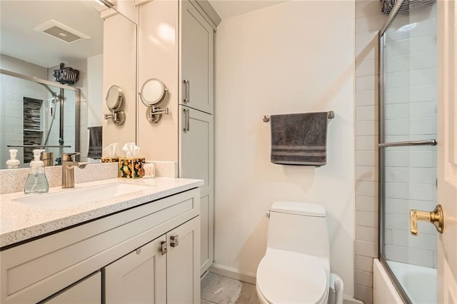 bathroom featuring vanity, baseboards, toilet, and visible vents