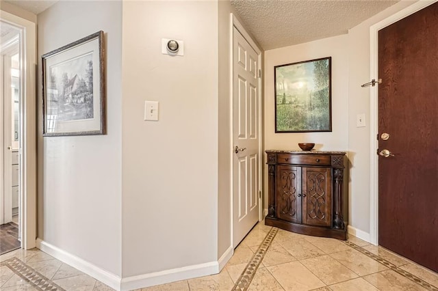 interior space featuring baseboards and a textured ceiling