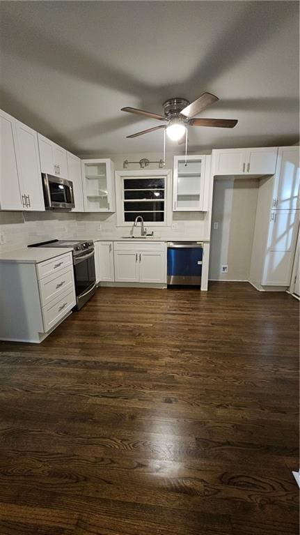 1080 Laboon Rd, Monroe, GA 30655 - kitchen with appliances with stainless steel finishes, a sink, white cabinetry, ceiling fan, and dark wood-style flooring