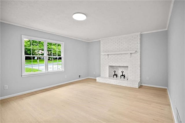 unfurnished living room featuring crown molding, light wood-style flooring, a fireplace, and baseboards