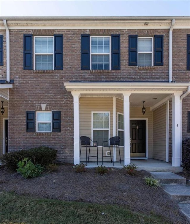 view of property featuring covered porch