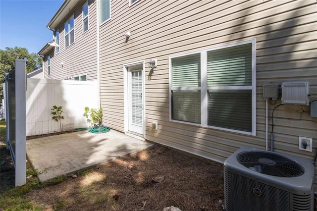 view of side of property featuring cooling unit and a patio area