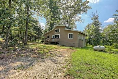 view of side of property with a deck and a yard