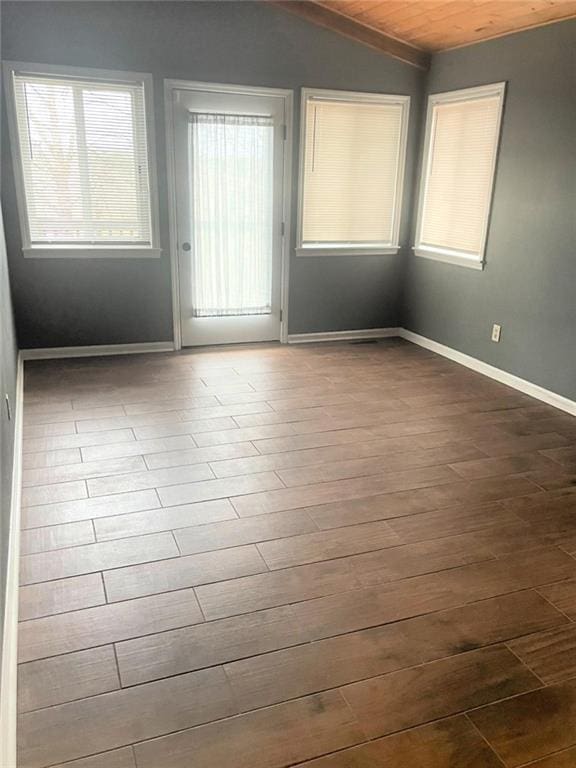 spare room with wooden ceiling, baseboards, vaulted ceiling, and dark wood-style flooring