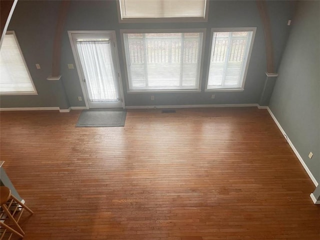 interior space featuring baseboards and hardwood / wood-style flooring