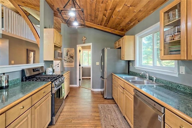 kitchen with lofted ceiling, wooden ceiling, light brown cabinets, stainless steel appliances, and a sink