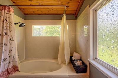 bathroom with shower / bath combination with curtain and wood ceiling