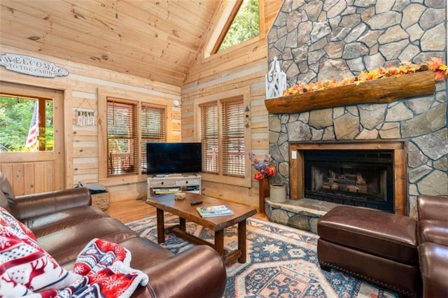 living room featuring a fireplace, wooden ceiling, hardwood / wood-style floors, wood walls, and high vaulted ceiling