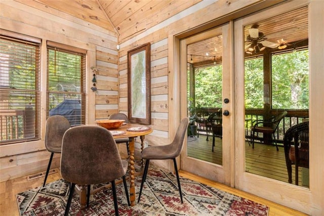 sunroom / solarium with lofted ceiling, plenty of natural light, and wooden ceiling