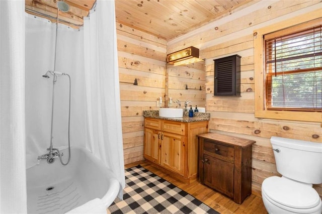 full bathroom featuring toilet, hardwood / wood-style floors, and wood walls