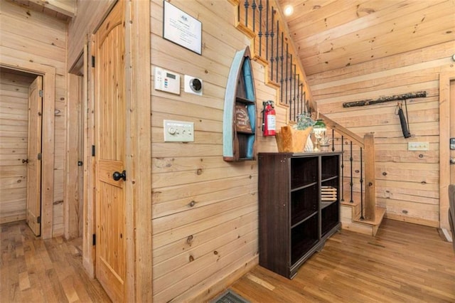 interior space featuring wood-type flooring and wood walls