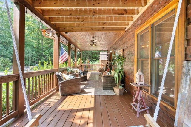 wooden terrace featuring ceiling fan and outdoor lounge area