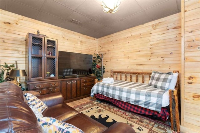 bedroom featuring wooden walls